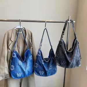 Denim tote bags in three colors featuring vintage letter patches and frayed edges