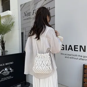 Chic cream macramé bucket bag with drawstring closure for bohemian summer beach style