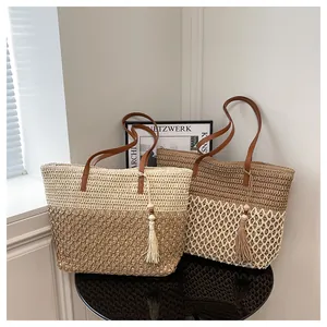 Detail of bohemian woven tote bags with leather straps and decorative tassels