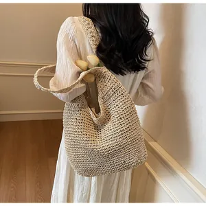 Detailed macro view of beige woven tote bag texture with 3D tulip floral decorations