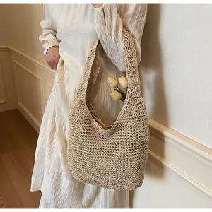 Detail of hand-woven beige tote bag with intricate hollow texture and tulip floral accent