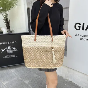 Vintage two-tone woven straw tote bag with leather straps and fringe tassel detail