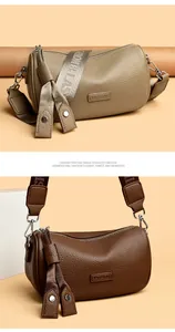 Detail von Zylindertaschen aus strukturiertem PU-Leder mit breiten Grafik-Schultergurten
