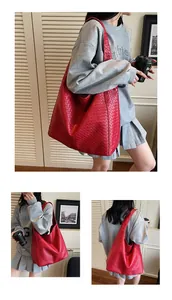 Detail of red woven large hobo bag showing the intricate texture and spacious tote design