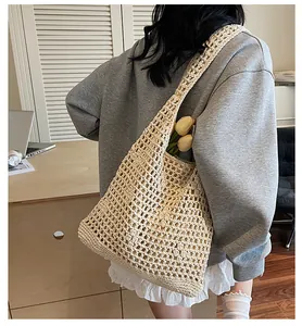 Detail shot of a beige woven hollow-out bucket bag with mesh texture and floral accents
