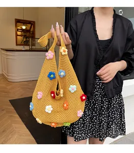 Detail of handmade yellow crochet tote bag with colorful 3D floral woven patterns