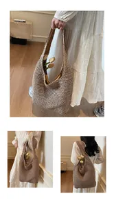 Detail of the woven texture and satin lining of this brown straw tote bag with tulips