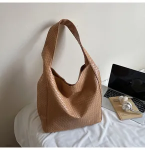 Detail of caramel brown woven leather hobo bag with high-capacity interior for office