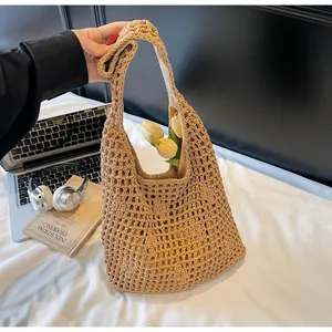 Close-up of hand-woven camel bucket bag with hollow mesh design and soft cloth lining