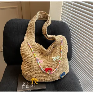 Close-up of woven tote bag featuring rainbow beads and colorful crochet bows decoration