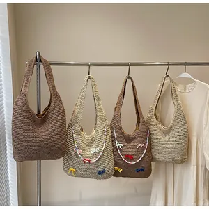 Detailed view of handmade woven tote bags with colorful beads and cute ribbon bows