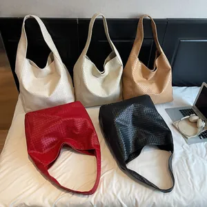 Large Intrecciato woven bucket bag in five colors with wide shoulder straps