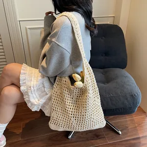 Chic hollow out crochet bucket bag for women featuring a cream woven beach shoulder design