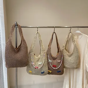 Handmade woven tote bag with cute bow and beaded charm for summer beach vacation style