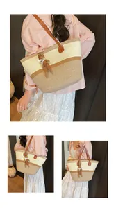 Detail view of woven leather patchwork tote bag with cute brown plush bunny charm
