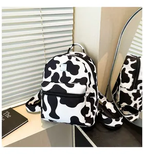 Detail of cow print backpack showing large zipper pockets and durable canvas texture