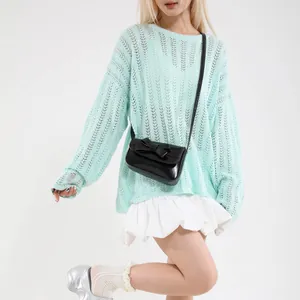 Chic mint green hollow knit sweater with long sleeves and elegant vertical pattern texture