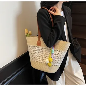 Detail of woven tote bag with hollow knit patterns and colorful crochet charm accessory