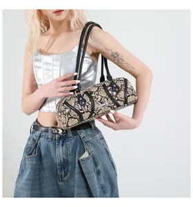 Close-up of brown snakeskin shoulder bag with black leather trim and silver metal hardware