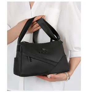 Détail du sac oreiller en nylon noir avec logo kangourou en métal et coutures géométriques