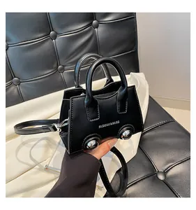 Macro view of black matte leather mini bag with silver studs and fashion text detail