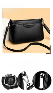 Close-up of glossy hardware and pebble leather texture on this black crossbody bag