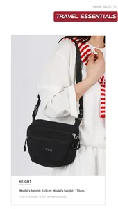 Close-up of black nylon crossbody bag featuring double zippers and adjustable buckle strap