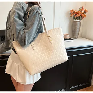 Detail of quilted beige tote bag showing large capacity and elegant gold metal rivets