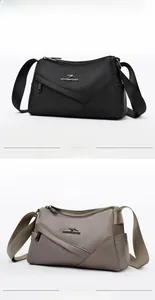 Vue verticale de sacs bandoulière en nylon noir et kaki avec plusieurs fermetures éclair