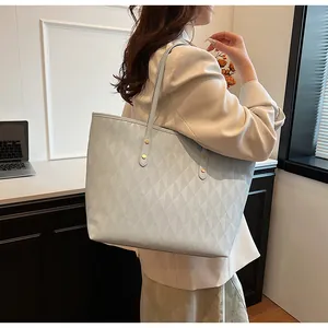 Modern light blue tote bag with geometric quilted pattern shown in a lifestyle setting