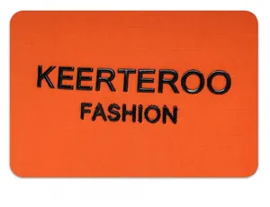 Detail of orange nylon fabric with 3D embossed logo showing high-quality texture