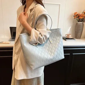 Large light blue quilted tote bag for women featuring stylish diamond lattice patterns