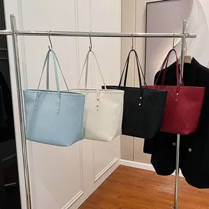 Spacious diamond quilted tote bags in blue, cream, black and red with slim handles