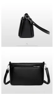 Detail view of black lychee grain crossbody bag with silver hardware and back zipper pocket