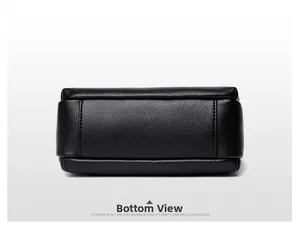 Detailed bottom view of black pebble leather crossbody bag with precise stitching