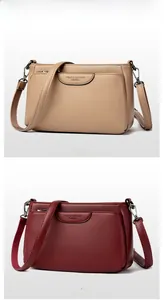 Detail of khaki and fuchsia crossbody bags featuring lychee grain texture and metal buckles