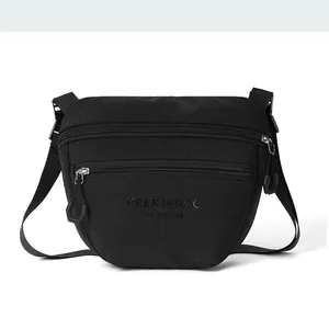 Close-up of durable black nylon shoulder bag featuring dual zipper layers and brand logo