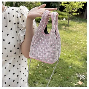 Detail of pink rhinestone bucket bag with sparkling metallic studs and chain strap