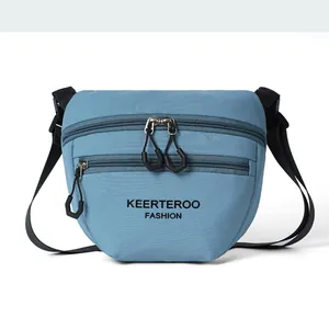 Detail view of the durable nylon crossbody bag with multi-zipper pockets and logo print
