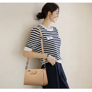 Brown faux leather crossbody bag for women with adjustable strap and textured finish