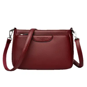 Versatile burgundy lychee pattern leather crossbody bag with adjustable silver strap