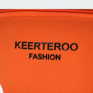 Detailed macro view of orange ripstop nylon fabric and branded zipper on shoulder bag