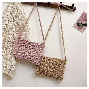 Macro shot of geometric macrame weaving pattern and fringe tassel on beach bag
