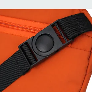 Detail of orange ripstop nylon fabric with black buckle and durable zipper strap