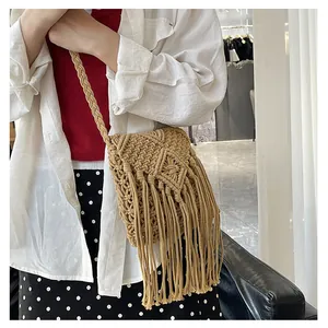 Detailed view of handmade woven crossbody bag with long tassels and diamond knit pattern