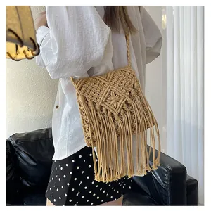 Detail of bohemian handmade woven cotton crossbody bag with intricate geometric tassels