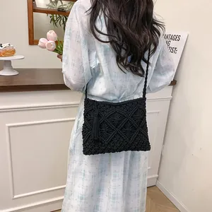 Handcrafted black cotton tassel woven shoulder bag with diamond pattern for beach leisure