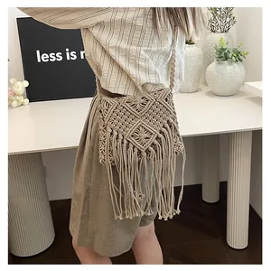 Detail of bohemian handmade cotton woven bag with geometric patterns and long fringes
