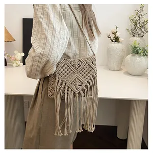 Detail of bohemian handmade woven shoulder bag with intricate tassels and diamond pattern