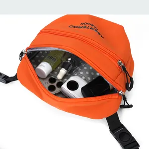 Detail view of the orange nylon crossbody bag showing spacious interior with polka dot lining